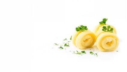 Three decorative curls of fresh butter garnished with parsley on a white plate, culinary presentation