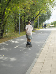 Person rollerblading on a park path active leisure vertical