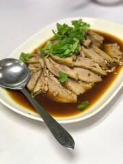Plate of Sliced Goose with Soy Sauce and Fresh Herbs