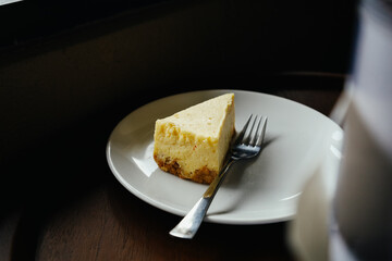 Delicious Slice of Cheesecake on a Plate in Restaurant Setting