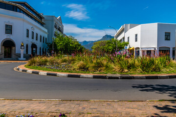 A view across a roundabout up main street in Stellenbosch, South Africa in springtime