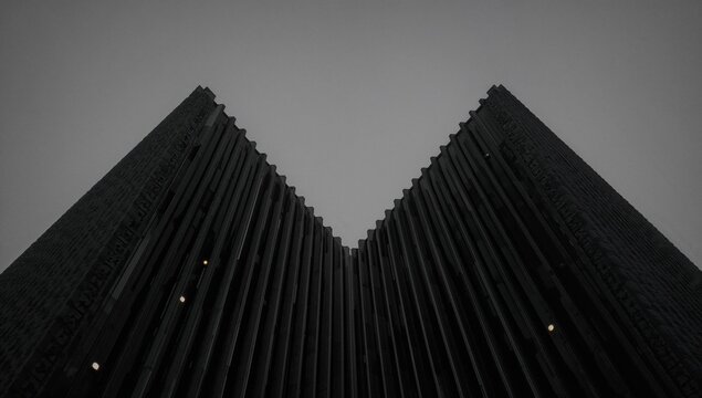 Double exposure featuring a lattice ceiling illuminated by spotlights against a monochrome geometric backdrop with contemporary architectural or interior elements - Powered by Adobe