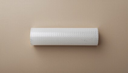 Obraz premium Roll of bubble wrap on cardboard surface, functional packing material for protection