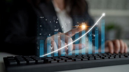 A businesswoman analyzes financial data with visual graphs and charts displayed on a digital screen, symbolizing growth and success in a modern office setting. Impute