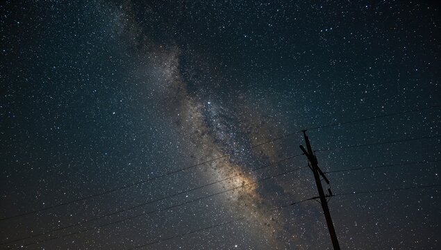 Silhouette of power lines and towers under a starry night sky, energy infrastructure, seasonal change - Powered by Adobe