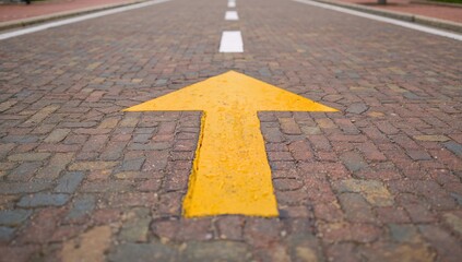Directional arrow on a vibrant paved road, guiding traffic flow