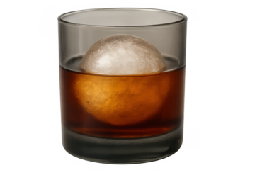 Whiskey drink with a large round ice ball in a glass, a classic spirit beverage with transparent background