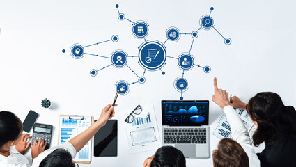 A team engages in data analysis using modern technology, showcasing collaboration and strategic planning in a contemporary office setting to enhance business performance. Amity