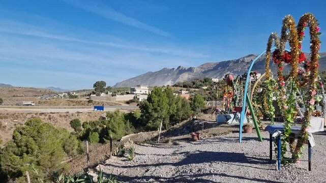 Decorative photo frames, including heart-shaped ones, set up for visitors to pose with the scenic Lac du Barrage Sed Nakhla dam in Zinat, Morocco, framed by mountains between Tetouan and Chefchaouen.
