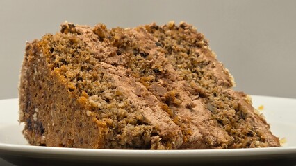 Piece of sweet chocolate cake with nuts. Delicious dessert, portion of tasty snack, closeup view