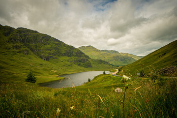 mountain landscape with lake in Scottish Highlands in a cloudy day