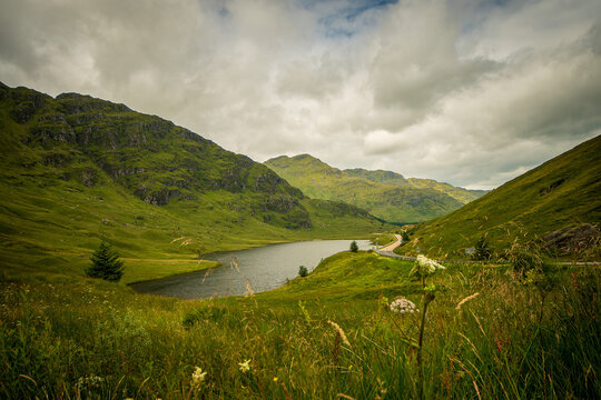 mountain landscape with lake in Scottish Highlands in a cloudy day