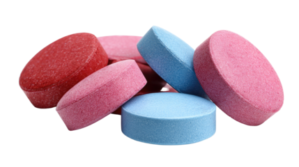 Vibrant colourful tablets arranged in scattered composition showcasing assorted medicine and supplement capsules for healthcare and pharmaceutical concepts isolated on white background