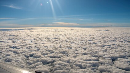 Aerial view of clouds above the horizon, showcasing atmospheric layers and light diffusion