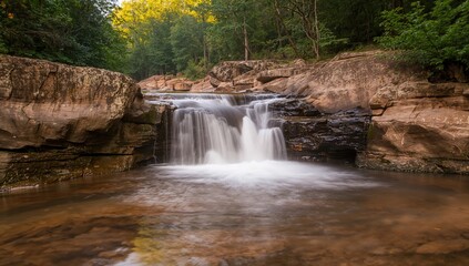 Fototapeta premium Evening small waterfall captured with long exposure, showcasing water motion and tranquility