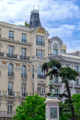 A typical street in central Madrid, lined with elegant historic buildings, balconies, and warm facades, capturing the city’s lively charm and timeless architecture