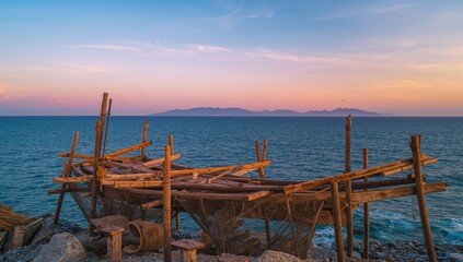 Ancient fishing apparatus illuminated by sunrise over a smooth sea surface, focusing on preservation