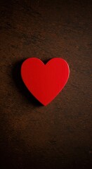 Obraz premium A vibrant red heart shape prominently displayed and completely isolated on a rustic, deeply textured brown background, symbolizing passion and love concept ,decoration ,affection ,feeling