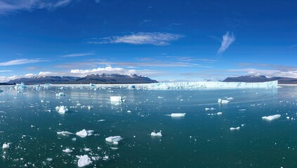 Panoramic view of icebergs adrift in a glacial lake, highlighting erosion risk