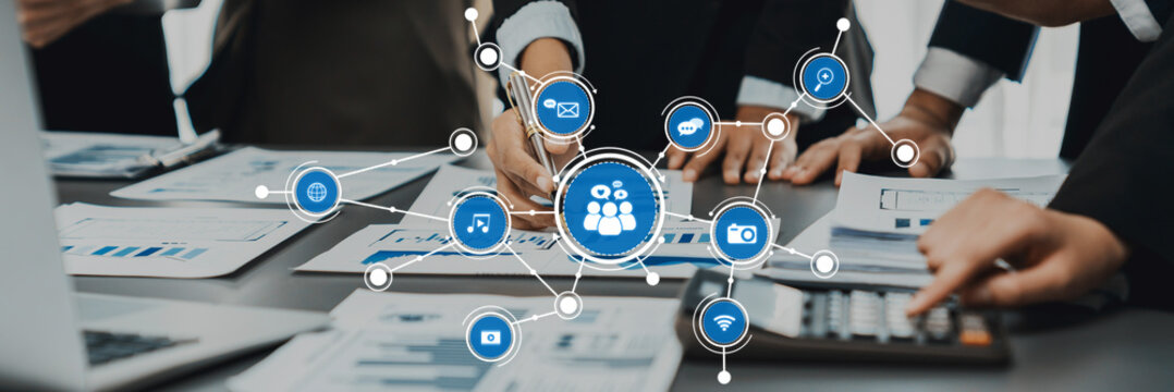 A dynamic business meeting showcasing collaboration among professionals using digital tools and analytics to enhance team performance in a modern office environment. Amity