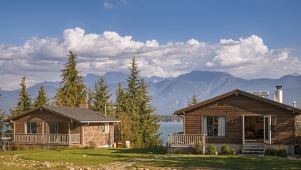 Vacation homes by a serene lake surrounded by majestic mountains, seasonal change