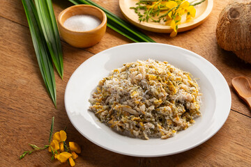 Sesbania flower dessert.Steamed Sesbania Flower with Rice Flour Shredded Coconut and sugar.
