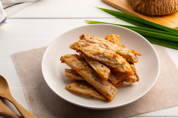 Deep fried Taro with sesame seeds.Thai snack ,Crispy Thai Taro Fritters in white plate.