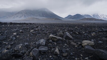 Volcanic hills shrouded in mist above a vast black lava expanse, erosion risk