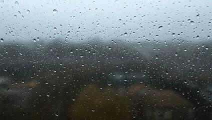 Obraz premium Raindrops clinging to a hotel balcony window, illustrating the impact of inclement weather