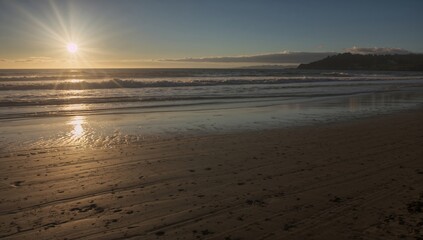 Waikuku Beach at Sunrise, serene landscape with warm hues, seasonal change