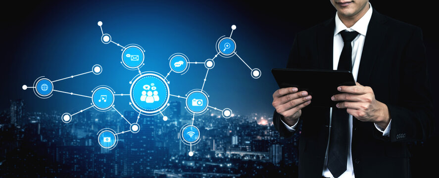 Businessman interacts with a tablet, surrounded by social media icons, representing modern networking and connectivity amidst a vibrant urban background. Tessel