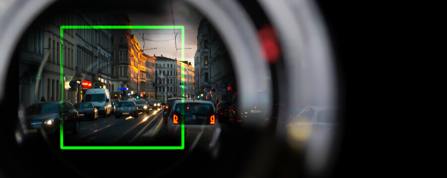 monitoring evening city traffic with a camera, scan car captures license plates and parking violations in real time, view from the driver's perspective, concept with copy space
