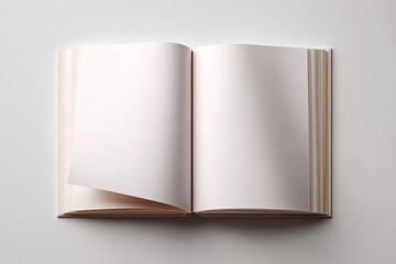 Open hardcover book with blank pages displayed on a smooth white surface from above