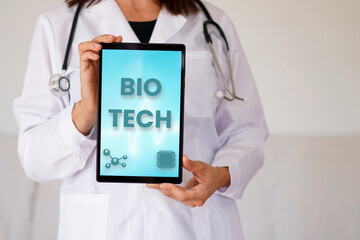 Bio Tech concept. female doctor with words written on a digital tablet