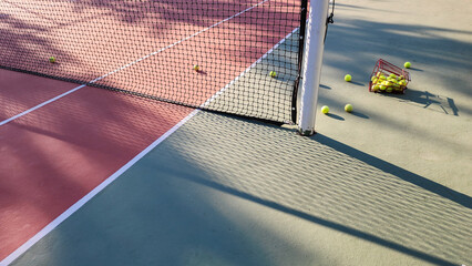 A detailed view of an empty tennis court and tennis ball.