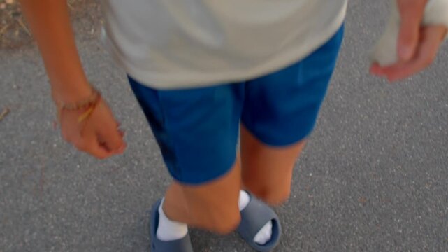 close-up caucasian teen quick footwork and crossover steps on road, playful training routine, athletic rhythm,