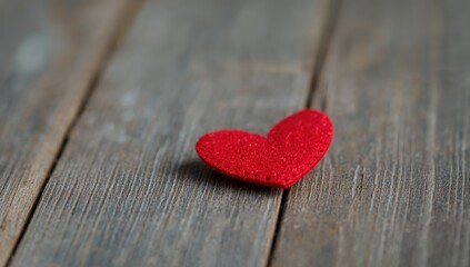Obraz premium Red heart made of felt against a grey wood surface, ideal for Valentine's Day