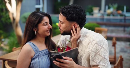 Hug, phone and roses with couple in garden of home together for romance or valentines day. App, dating and flower bouquet with happy people embracing outdoor for bonding, connection or memories - Powered by Adobe
