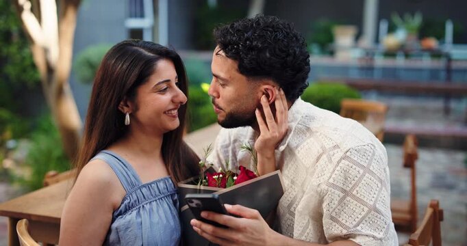 Hug, phone and roses with couple in garden of home together for romance or valentines day. App, dating and flower bouquet with happy people embracing outdoor for bonding, connection or memories - Powered by Adobe