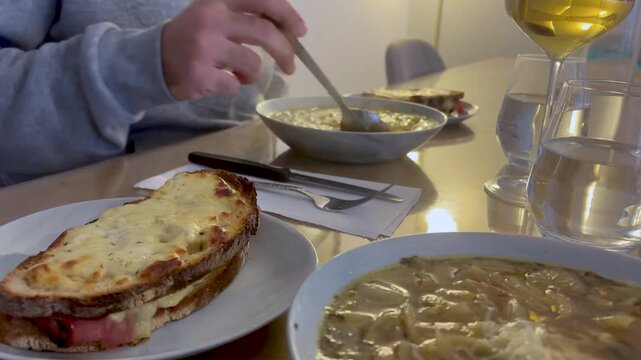 Intimate candid lifestyle shot of hands, cutlery, and dinner.