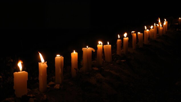 Candles arranged in a row with flames lit