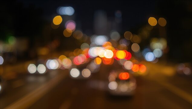 Colorful bokeh blur of vehicle lights at night, urban landscape background for editorial use - Powered by Adobe