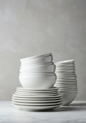 A clean, minimalist composition of stacked white porcelain crockery including bowls and dinner plates, suitable for modern kitchen design and restaurants, food preparation, stacked, minimalist