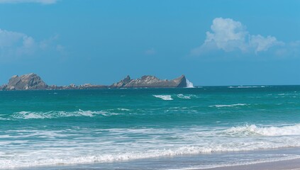 Ocean waves crashing against rocky shore, seasonal change