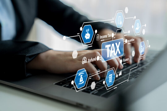 A close-up view of hands typing on a laptop, surrounded by digital tax icons that illustrate various financial concepts and services relevant in today business world. Tessel