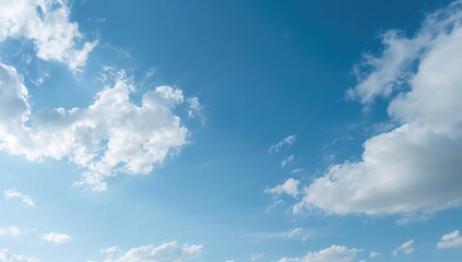 A serene blue sky with fluffy white clouds, providing a peaceful backdrop for reflection