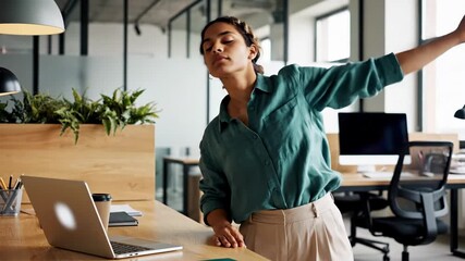 A tranquil office yoga pause captures a calm female employee stretching beside her workstation, promoting corporate wellness, focus, and stress relief in a modern workplace.