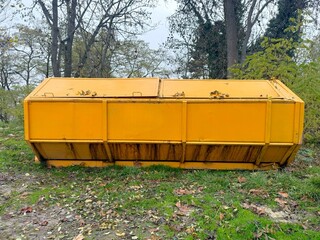 Large Long Yellow Dumpster outside