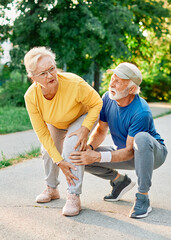 Active senior people jogging together injury problem  in the park
