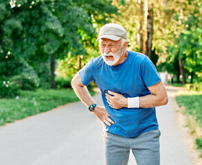 portrait of a senior man exercising and running outdoors having cardio problems chest pain